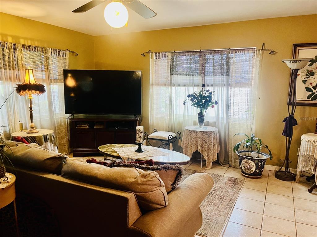 883 10th Street Clermont, FL 34711 - Photo 27 of 42 a living room with furniture and a flat screen tv