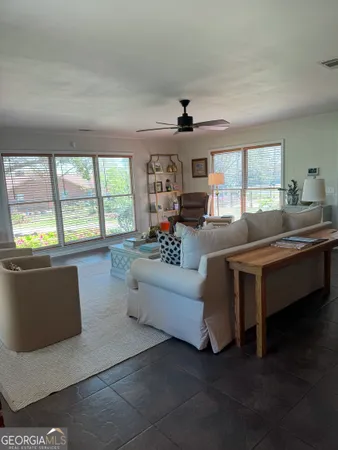 a living room with furniture and windows