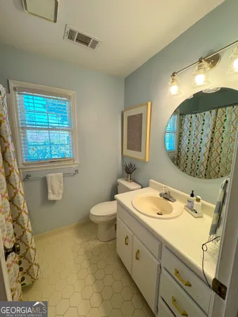 a bathroom with a sink toilet and mirror