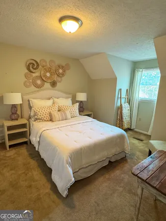 a bedroom with a bed and a mirror