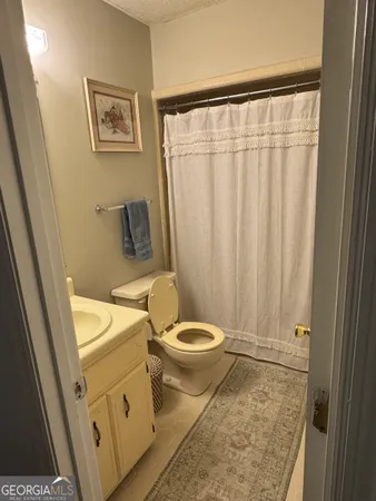 a bathroom with a toilet a sink and a shower
