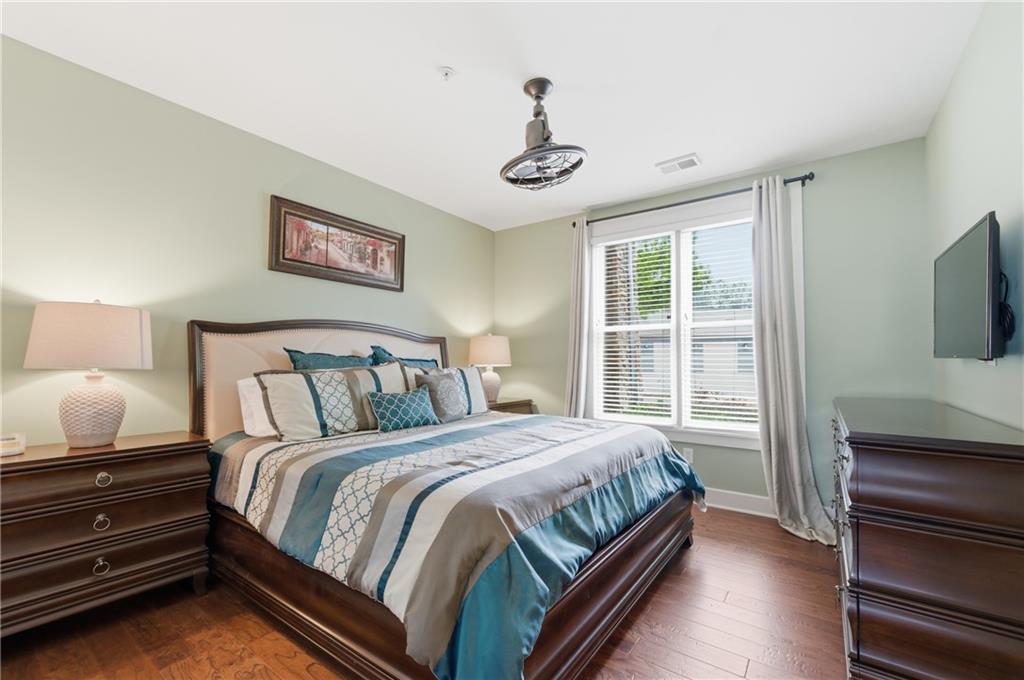 117 South Bay Road, Unit 402 Eatonton, GA 31024 - Photo 12 of 48 a bedroom with a bed and a flat screen tv