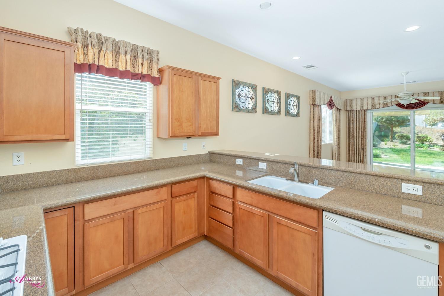 Undisclosed Address Bakersfield, CA 93306 - Photo 14 of 51 a kitchen with a sink and cabinets