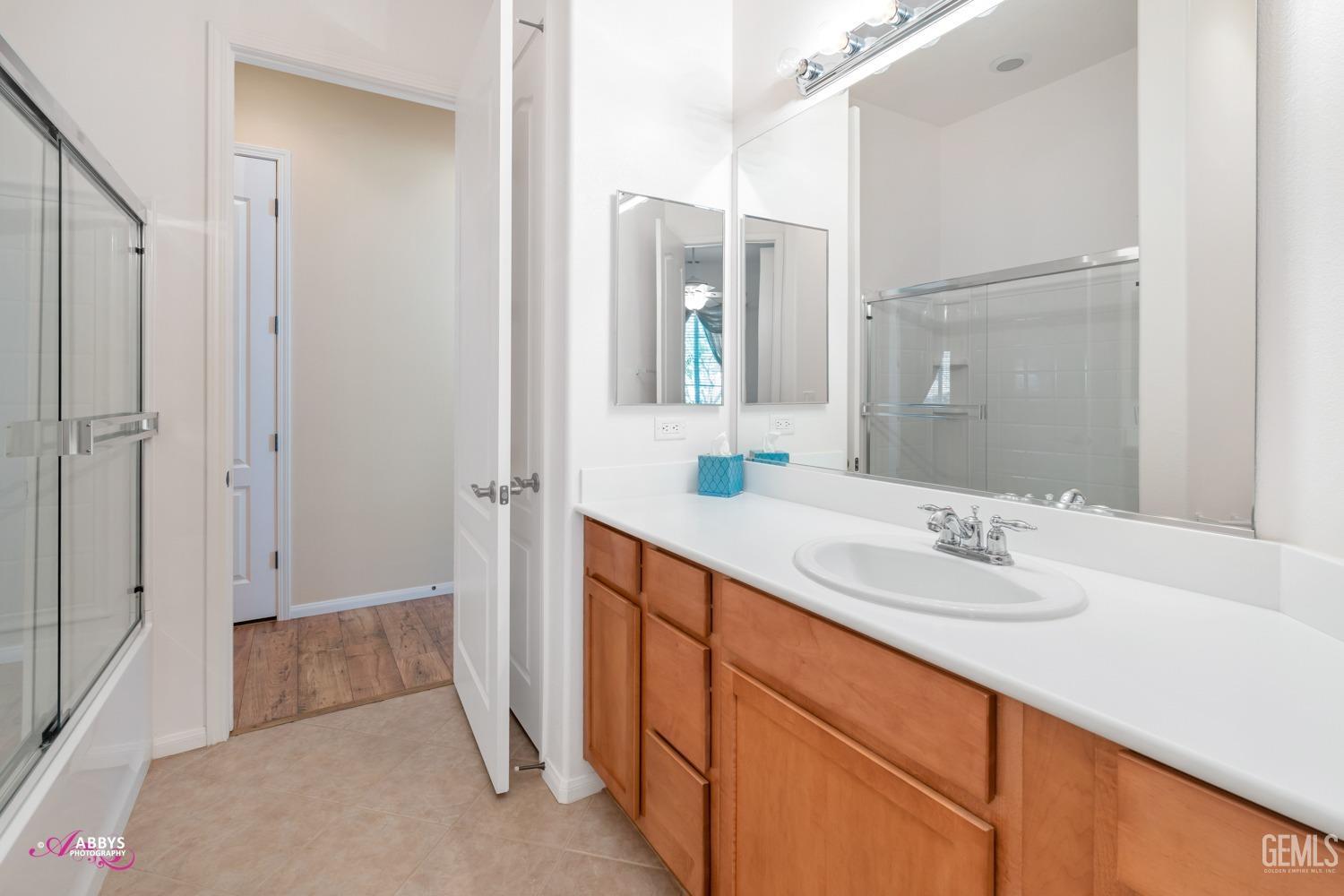 Undisclosed Address Bakersfield, CA 93306 - Photo 16 of 51 a spacious bathroom with a sink and a mirror