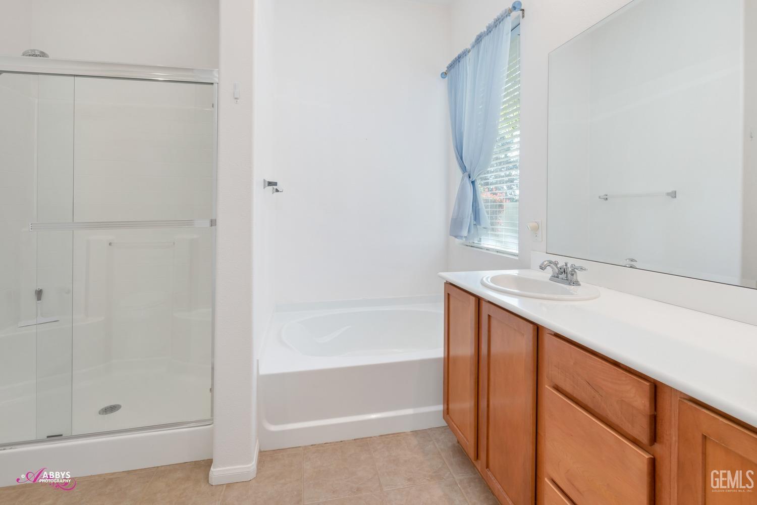 Undisclosed Address Bakersfield, CA 93306 - Photo 20 of 51 a bathroom with a sink and a mirror