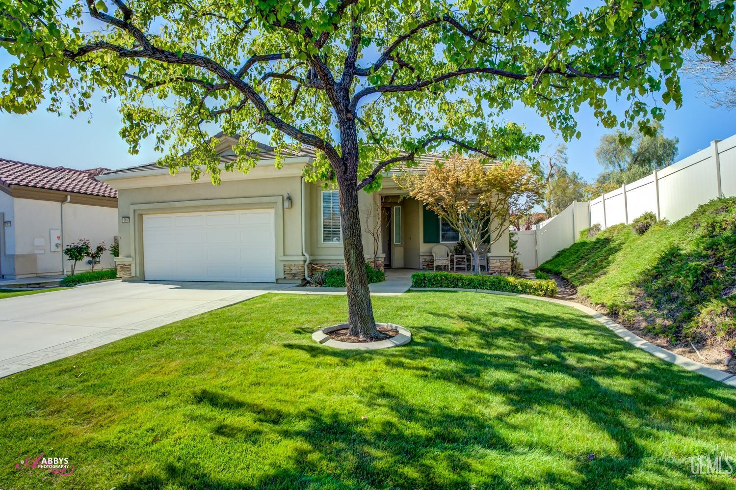Undisclosed Address Bakersfield, CA 93306 - Photo 2 of 51 a front view of a house with garden