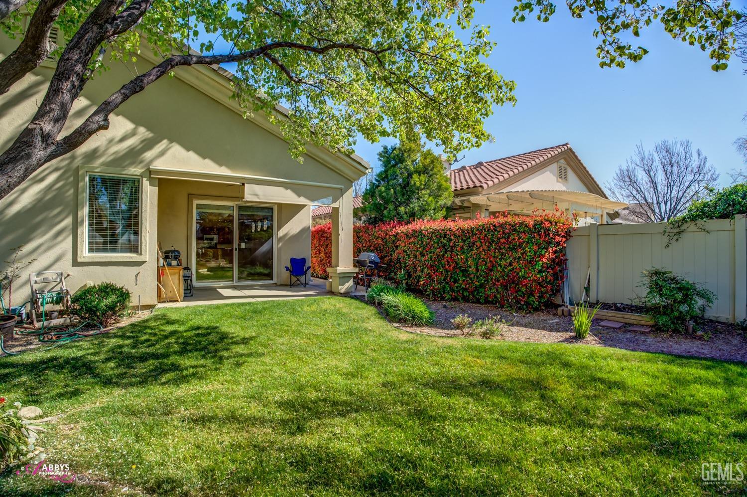 Undisclosed Address Bakersfield, CA 93306 - Photo 24 of 51 a view of a house with a backyard and a patio