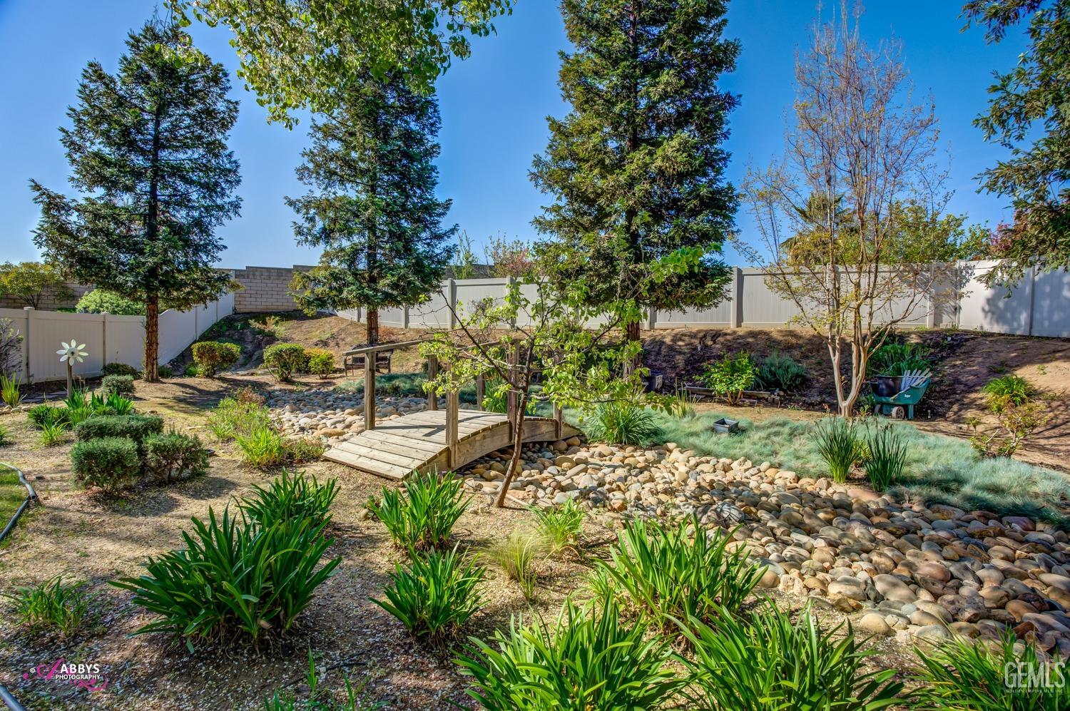 Undisclosed Address Bakersfield, CA 93306 - Photo 28 of 51 a view of a garden with a fountain