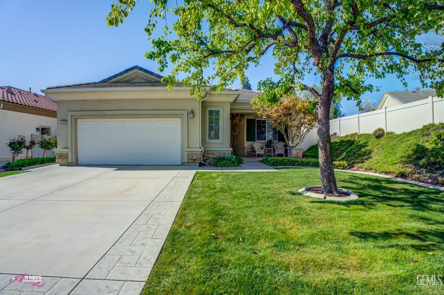 Undisclosed Address Bakersfield, CA 93306 - Photo 3 of 51 a front view of a house with garden