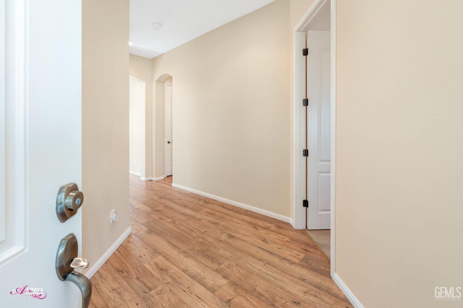 Undisclosed Address Bakersfield, CA 93306 - Photo 6 of 51 a view of a livingroom with wooden floor and bathroom