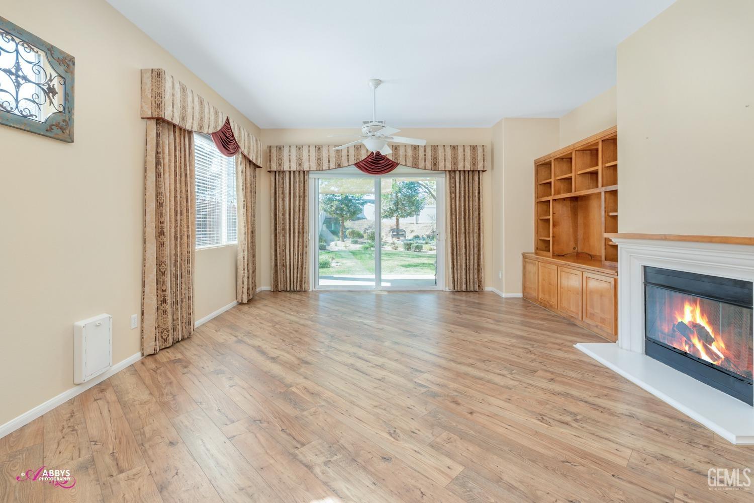 Undisclosed Address Bakersfield, CA 93306 - Photo 8 of 51 a view of a room with wooden floor fireplace and windows