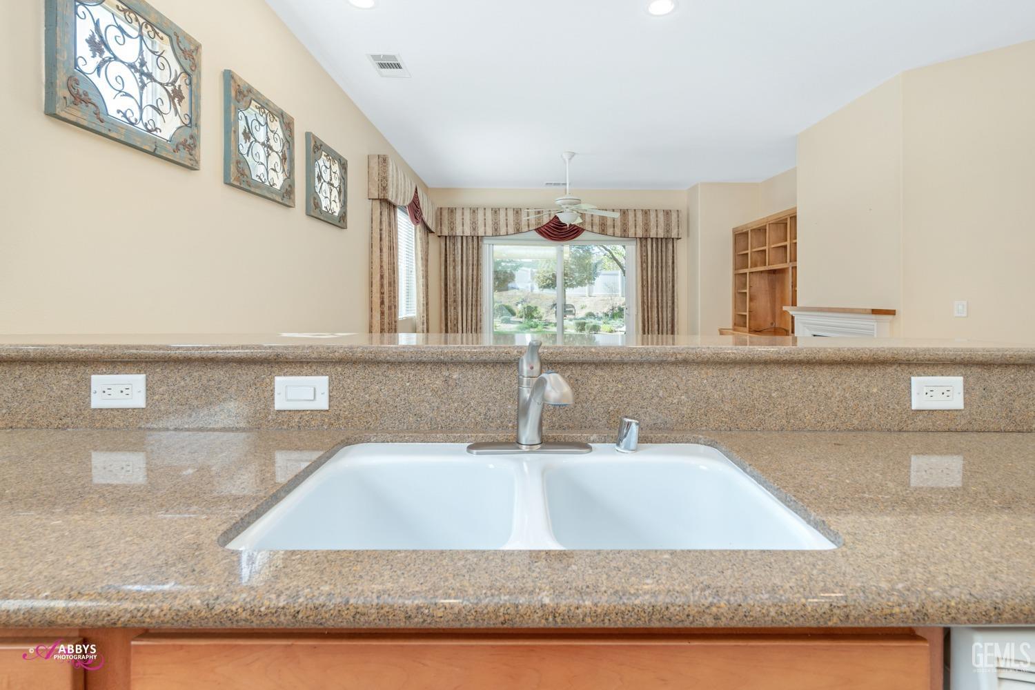 Undisclosed Address Bakersfield, CA 93306 - Photo 10 of 51 a bathroom with a granite countertop sink a large mirror and vanity