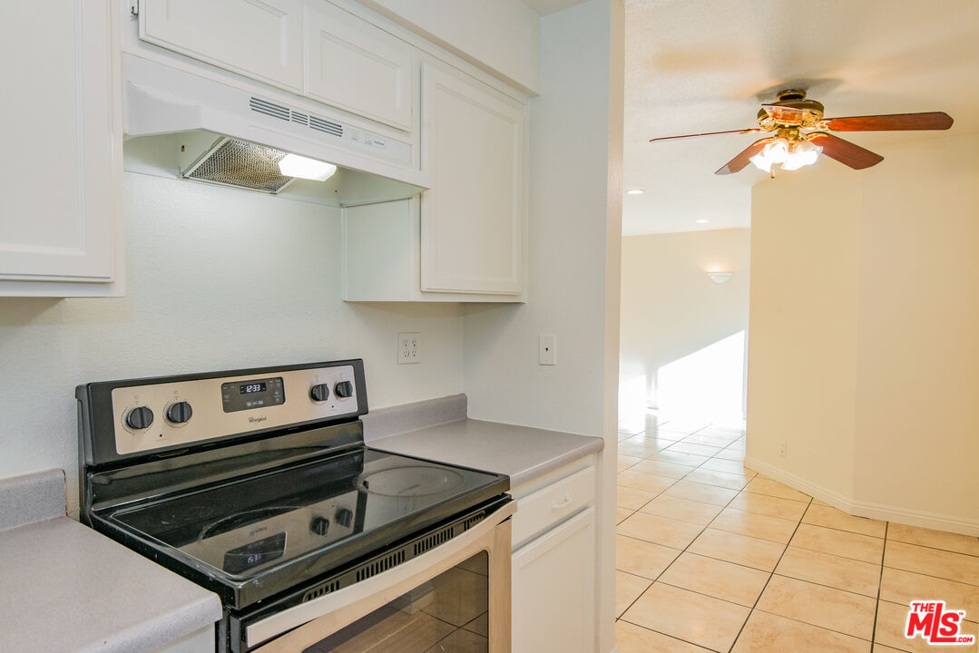 7651 Reseda Boulevard, Unit 3T Reseda, CA 91335 - Photo 21 of 32 a kitchen with a stove and a microwave