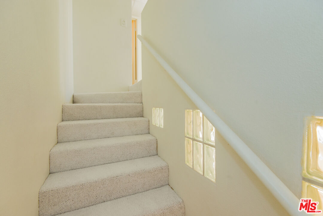 7651 Reseda Boulevard, Unit 3T Reseda, CA 91335 - Photo 27 of 32 a view of staircase with white walls and windows