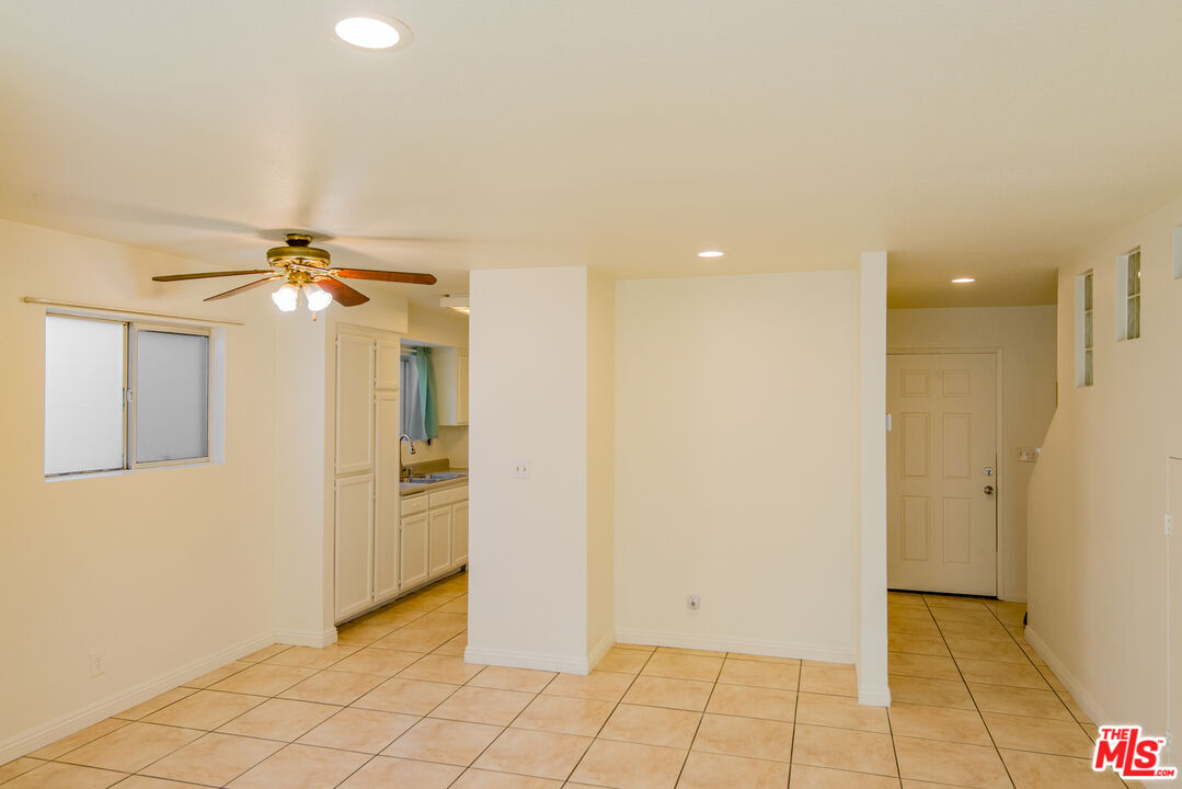7651 Reseda Boulevard, Unit 3T Reseda, CA 91335 - Photo 31 of 32 an empty room with closet and a chandelier fan