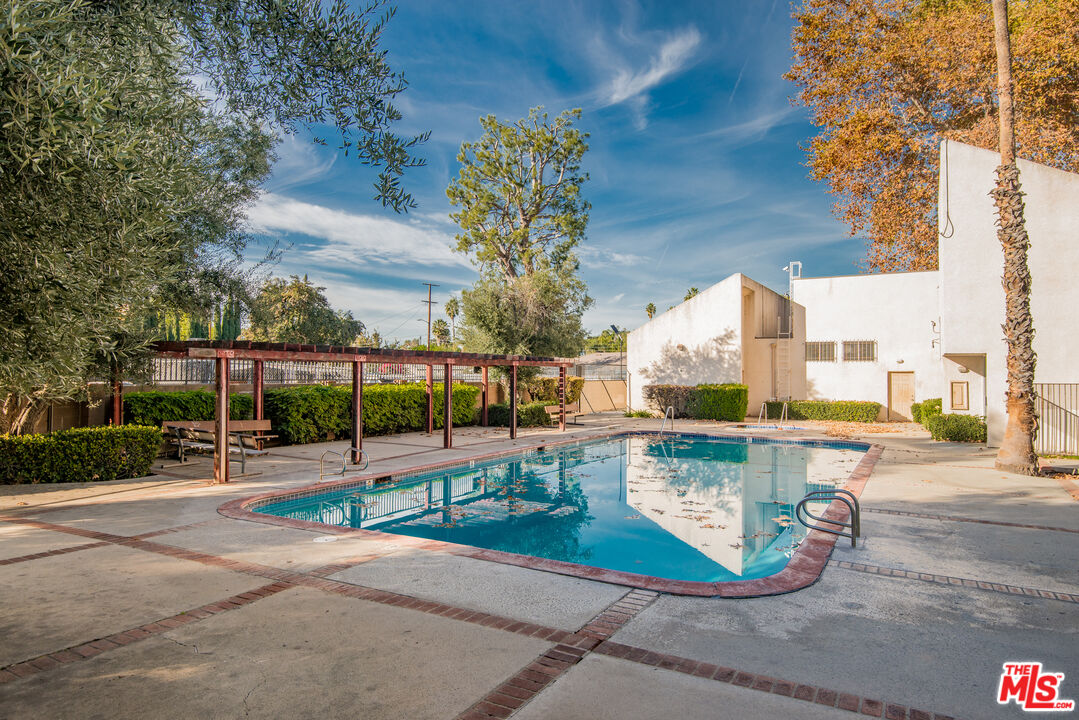 7651 Reseda Boulevard, Unit 3T Reseda, CA 91335 - Photo 10 of 32 a view of a swimming pool with a patio