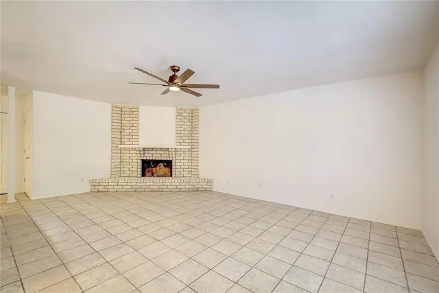 a view of an empty room with a fireplace