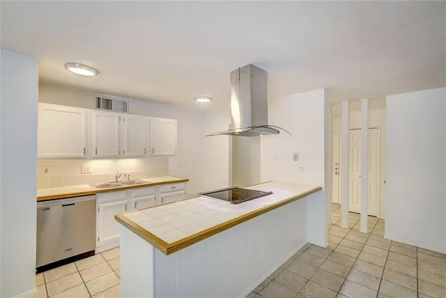 a kitchen with a sink refrigerator and cabinets