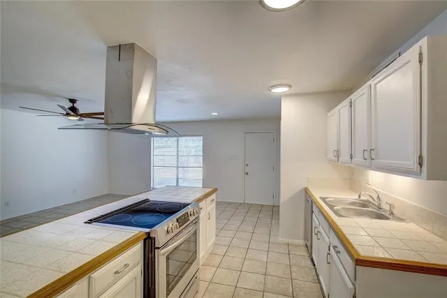 a kitchen that has a sink and a stove