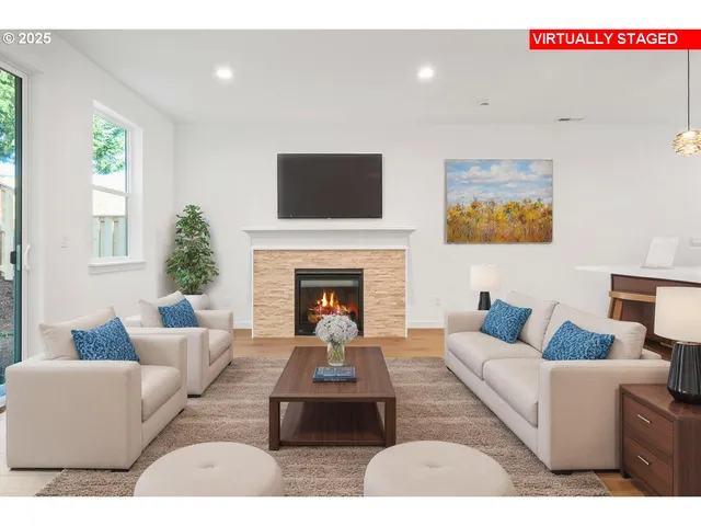 a living room with furniture fireplace and window