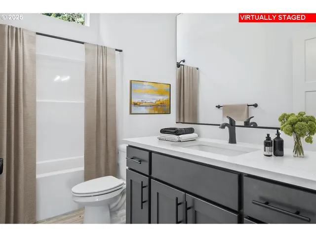 a bathroom with a toilet a sink and mirror