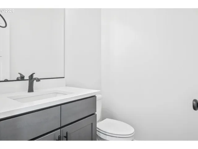 a bathroom with a sink a toilet and mirror