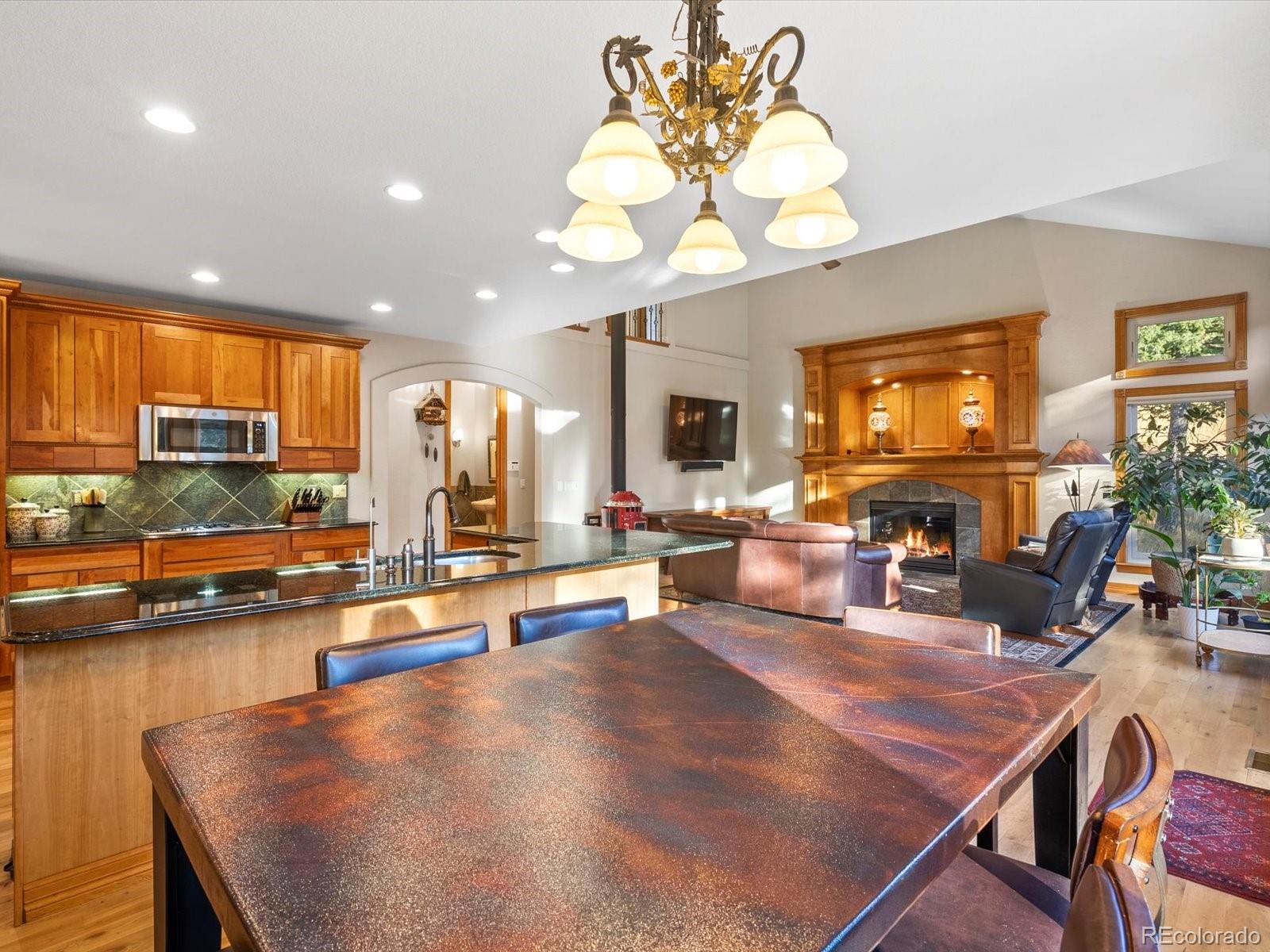 20906 Horse-Bit Way Morrison, CO 80465 - Photo 20 of 49 a view of a dining room with furniture a chandelier and wooden floor