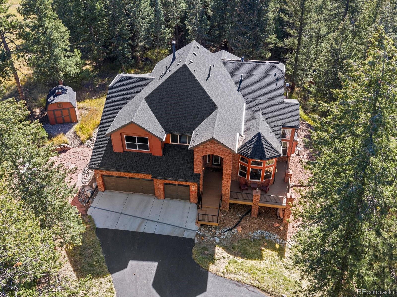20906 Horse-Bit Way Morrison, CO 80465 - Photo 2 of 49 an aerial view of a house with swimming pool and sitting area