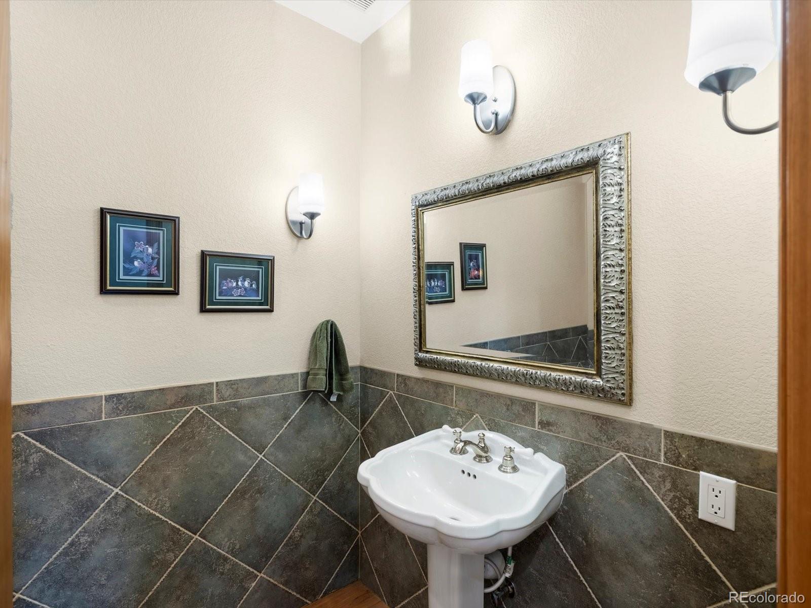 20906 Horse-Bit Way Morrison, CO 80465 - Photo 27 of 49 a bathroom with a sink and a mirror