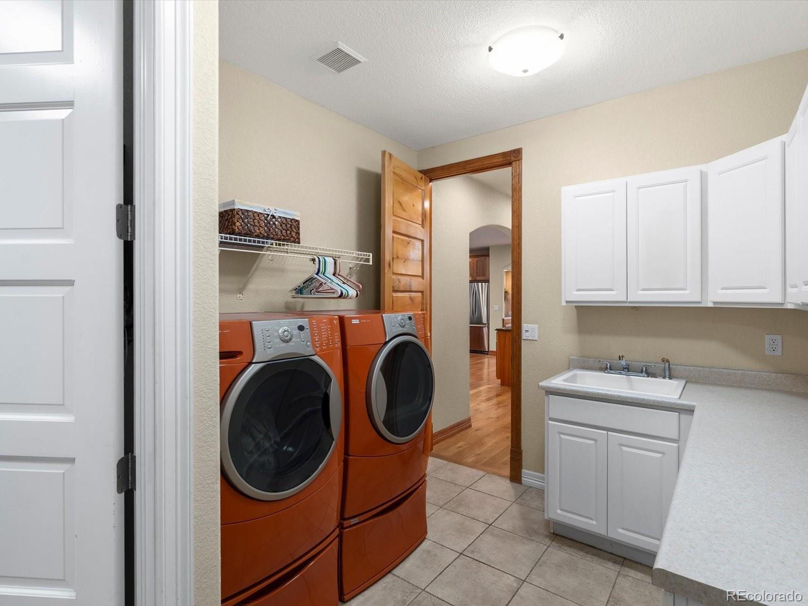 20906 Horse-Bit Way Morrison, CO 80465 - Photo 28 of 49 a utility room with sink dryer and washer