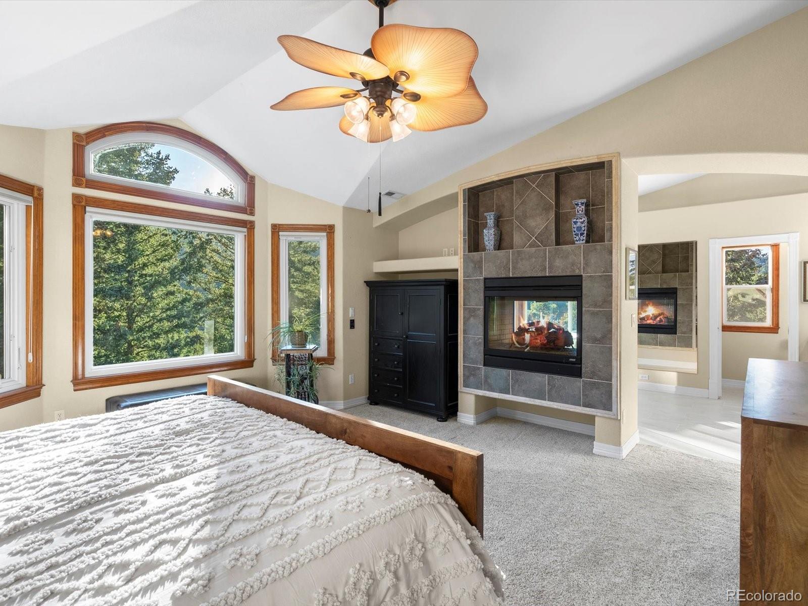 20906 Horse-Bit Way Morrison, CO 80465 - Photo 29 of 49 a bedroom with a bed and a fireplace