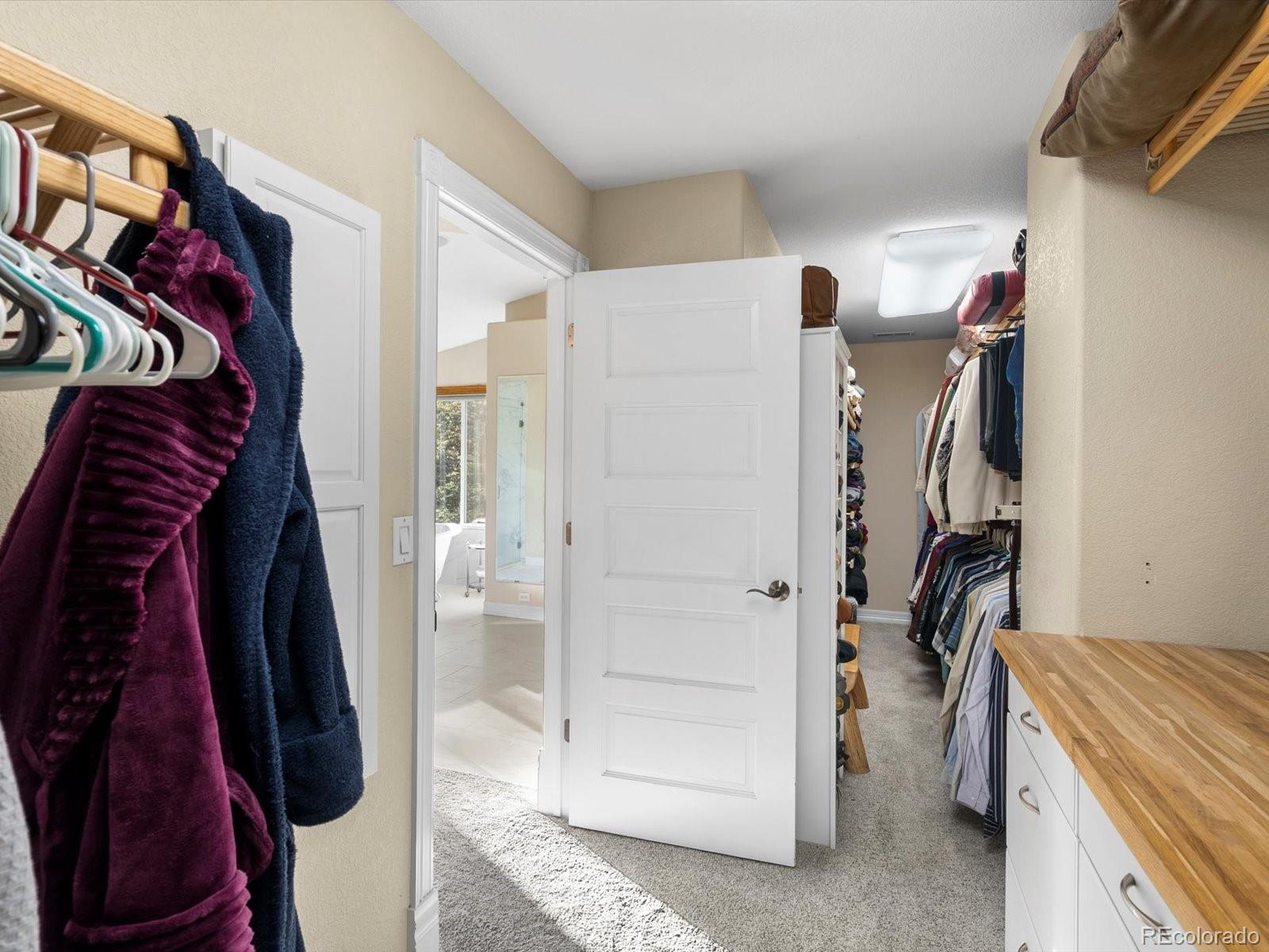 20906 Horse-Bit Way Morrison, CO 80465 - Photo 34 of 49 a view of walk in closet with clothes and shoes