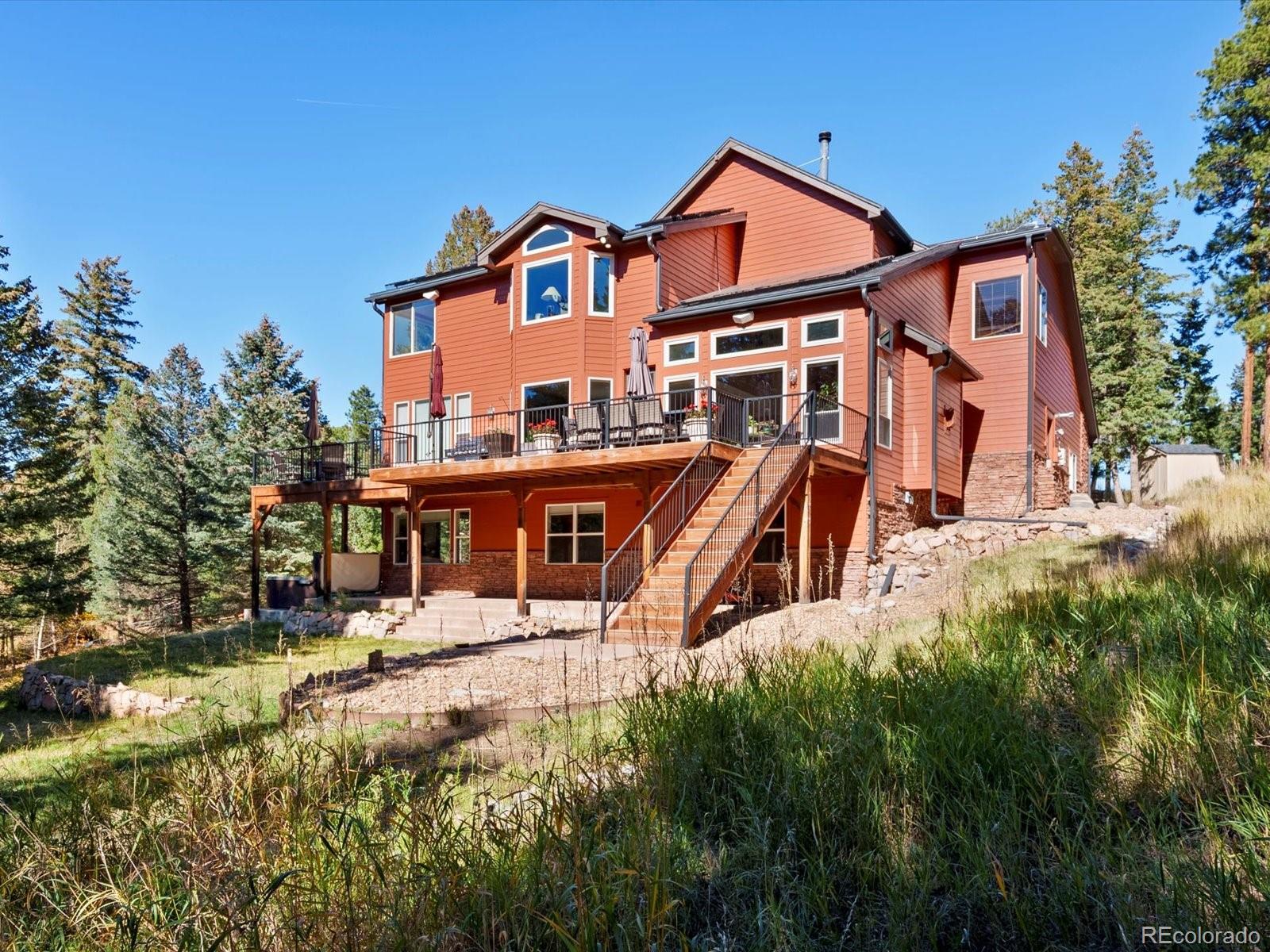 20906 Horse-Bit Way Morrison, CO 80465 - Photo 49 of 49 an aerial view of a house with swimming pool and sitting area