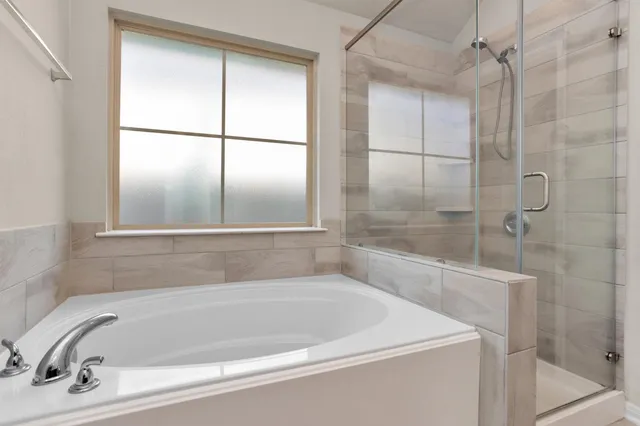 a white bath tub sitting next to a window