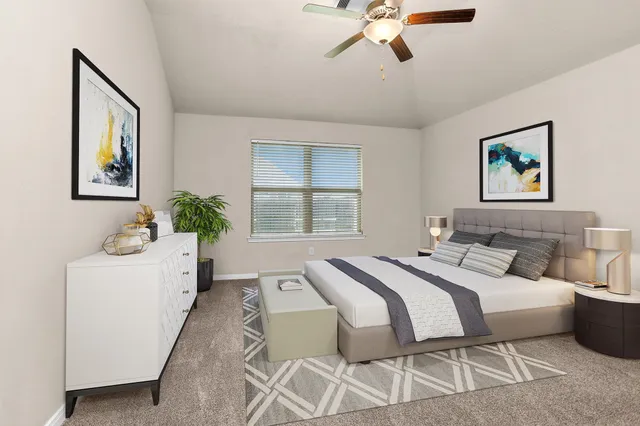 a bedroom with a bed and a painting on the wall