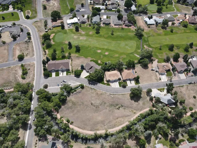 an aerial view of residential houses with outdoor space and swimming pool