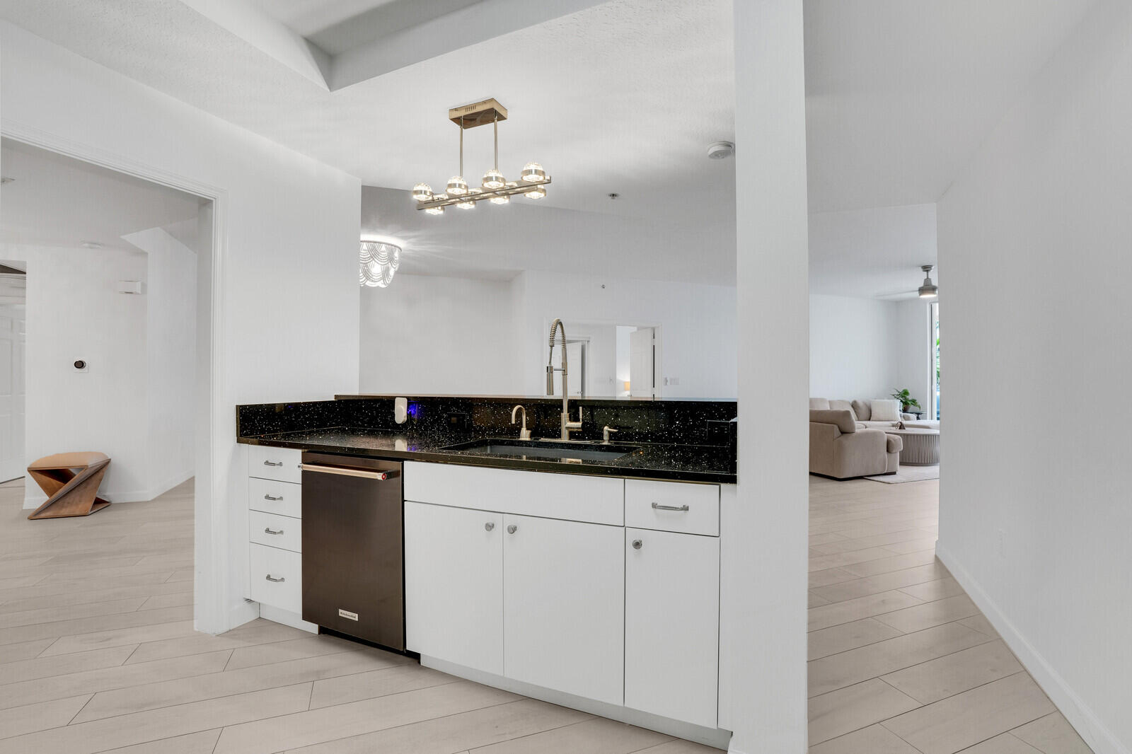 120 Ocean Grande Boulevard, Unit 2 Jupiter, FL 33477 - Photo 12 of 47 a kitchen with granite countertop a sink and cabinets