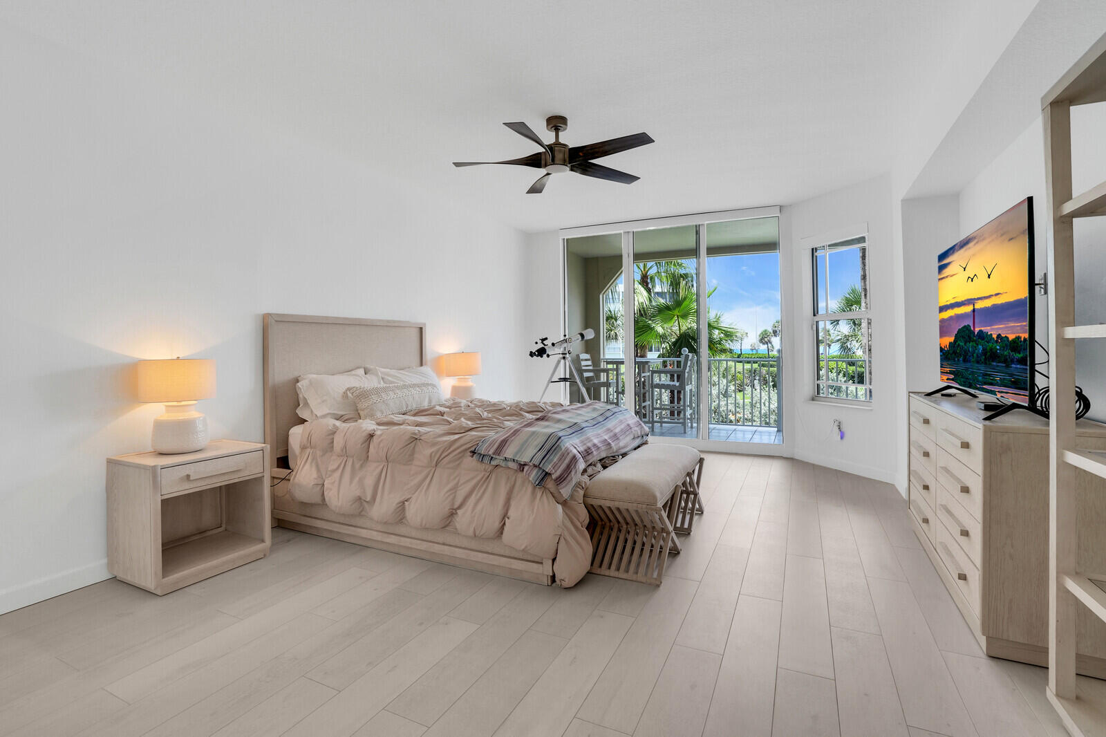 120 Ocean Grande Boulevard, Unit 2 Jupiter, FL 33477 - Photo 17 of 47 a bedroom with a bed and a flat tv screen on dresser