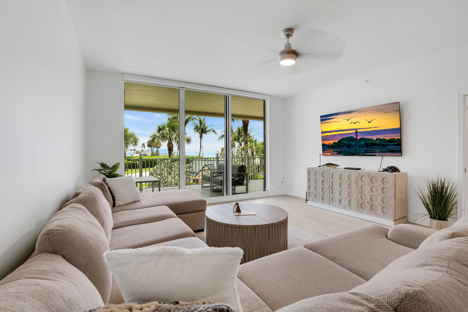 120 Ocean Grande Boulevard, Unit 2 Jupiter, FL 33477 - Photo 2 of 47 a living room with furniture and a flat screen tv