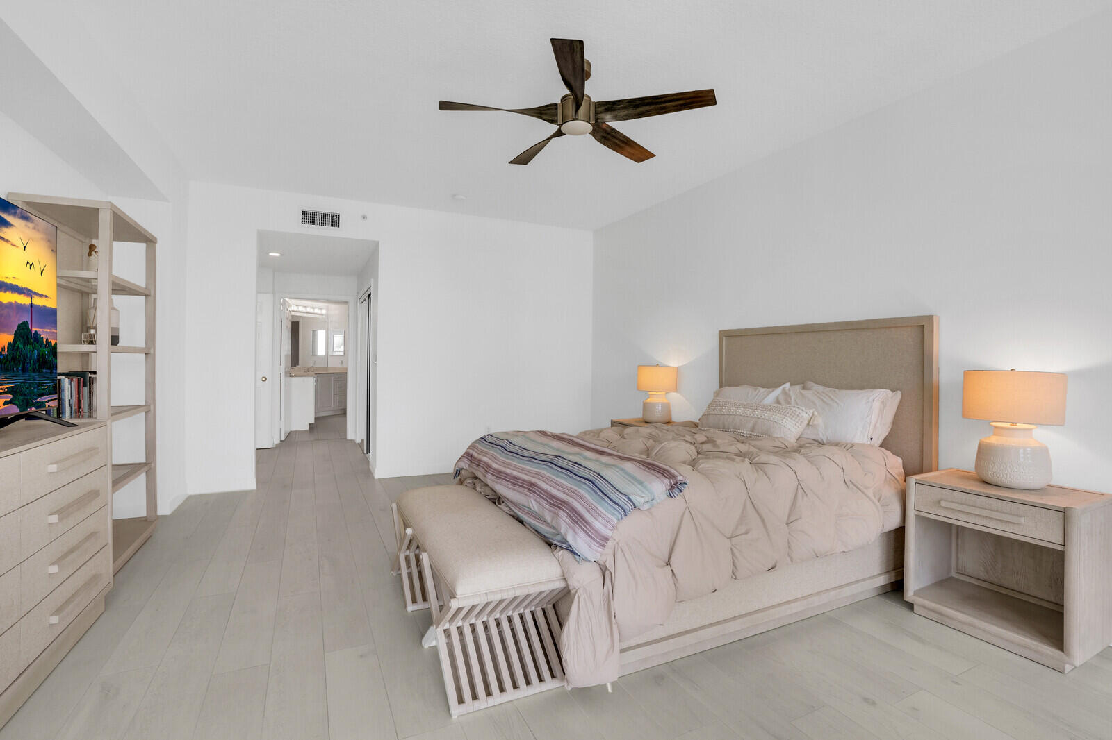 120 Ocean Grande Boulevard, Unit 2 Jupiter, FL 33477 - Photo 21 of 47 a bedroom with a bed and a chandelier