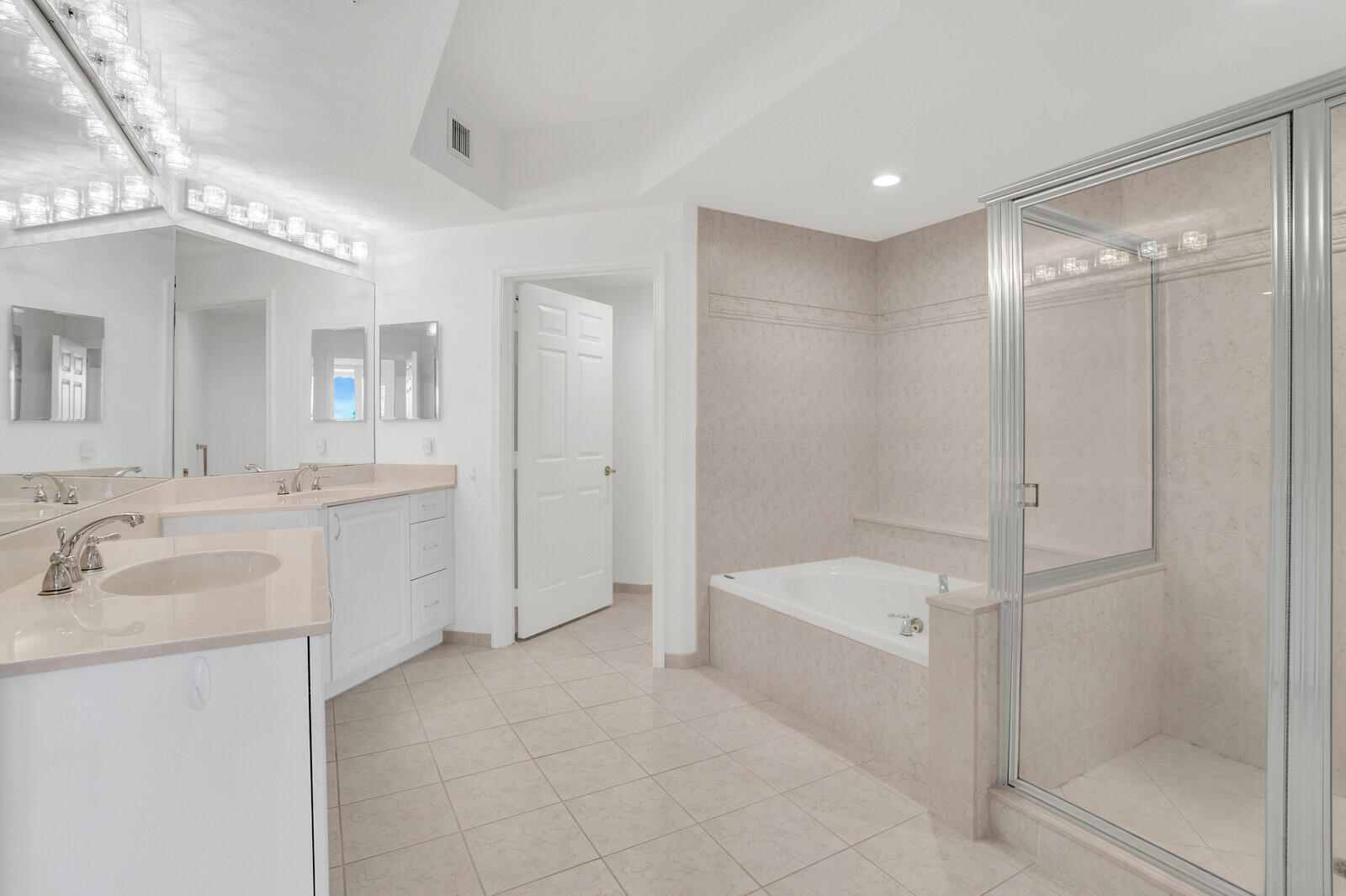 120 Ocean Grande Boulevard, Unit 2 Jupiter, FL 33477 - Photo 22 of 47 a bathroom with a tub shower sink and mirror