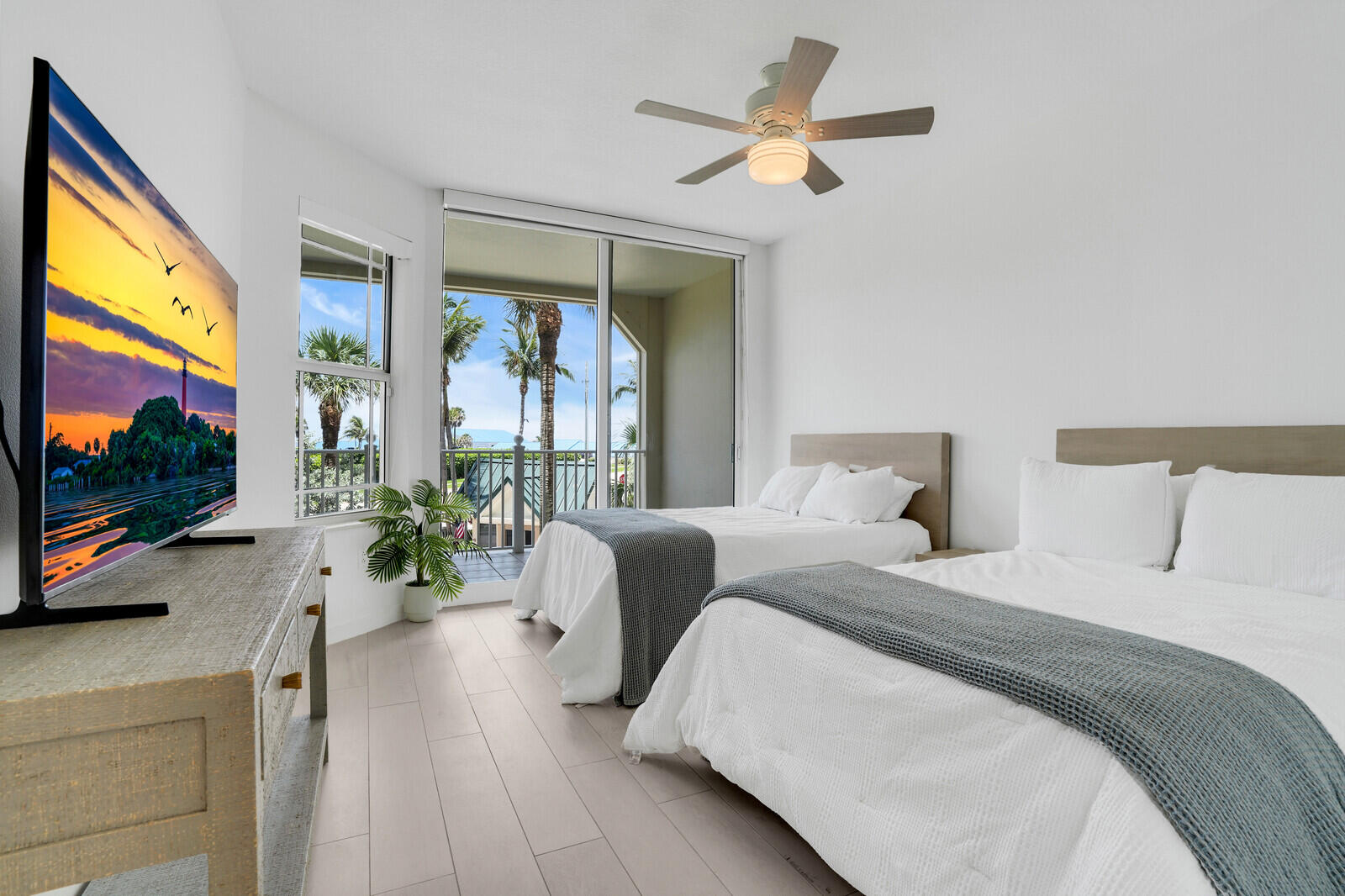 120 Ocean Grande Boulevard, Unit 2 Jupiter, FL 33477 - Photo 26 of 47 a bedroom with a large bed and a flat screen tv