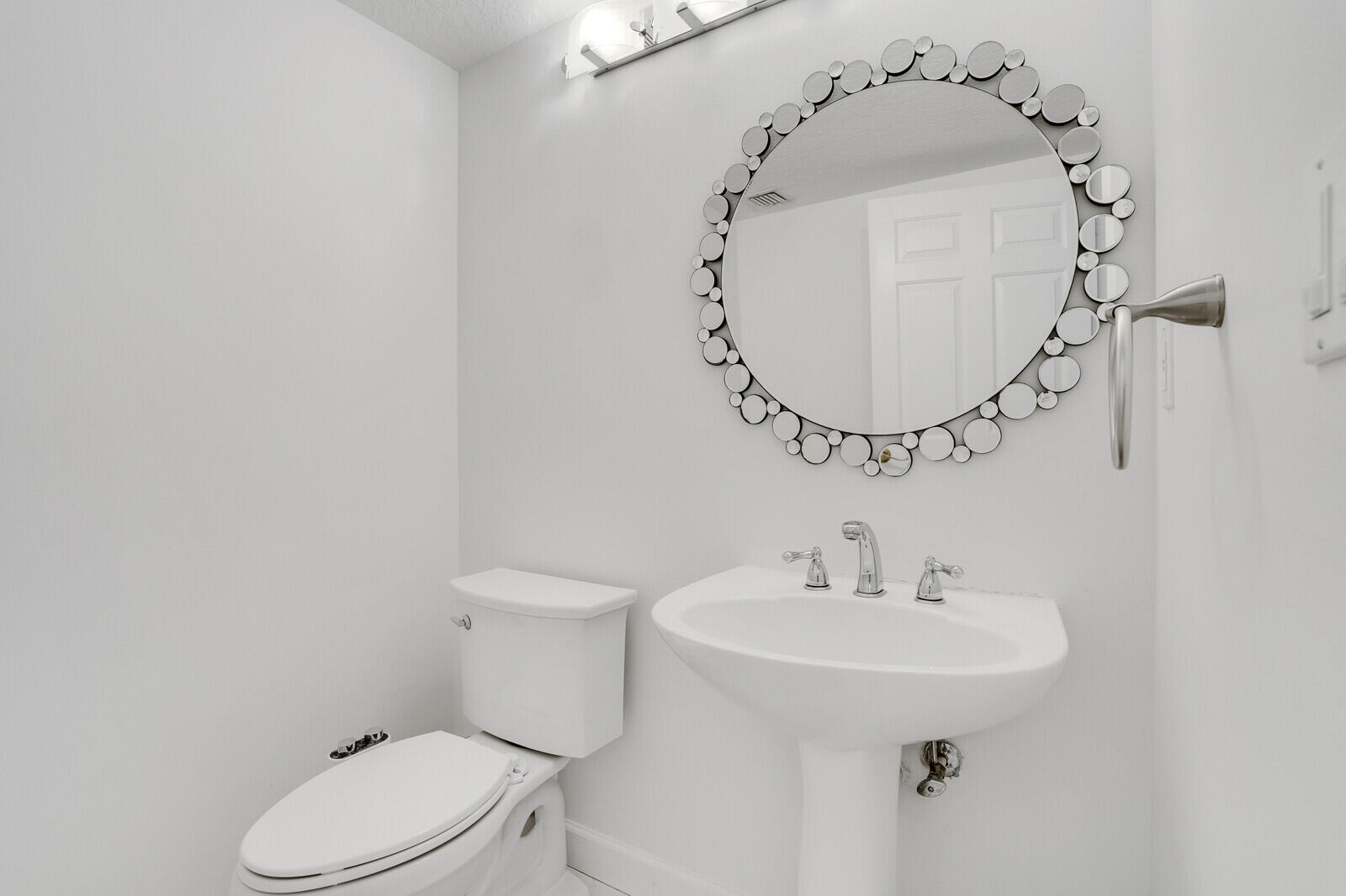 120 Ocean Grande Boulevard, Unit 2 Jupiter, FL 33477 - Photo 29 of 47 a bathroom with a sink toilet and mirror
