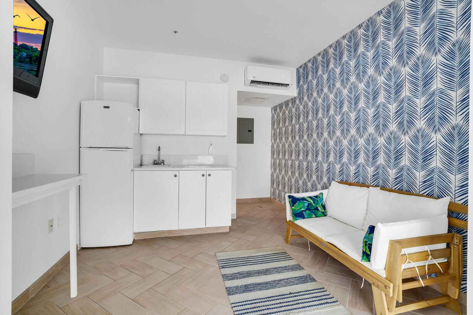 120 Ocean Grande Boulevard, Unit 2 Jupiter, FL 33477 - Photo 31 of 47 a view of kitchen with furniture and flat screen tv