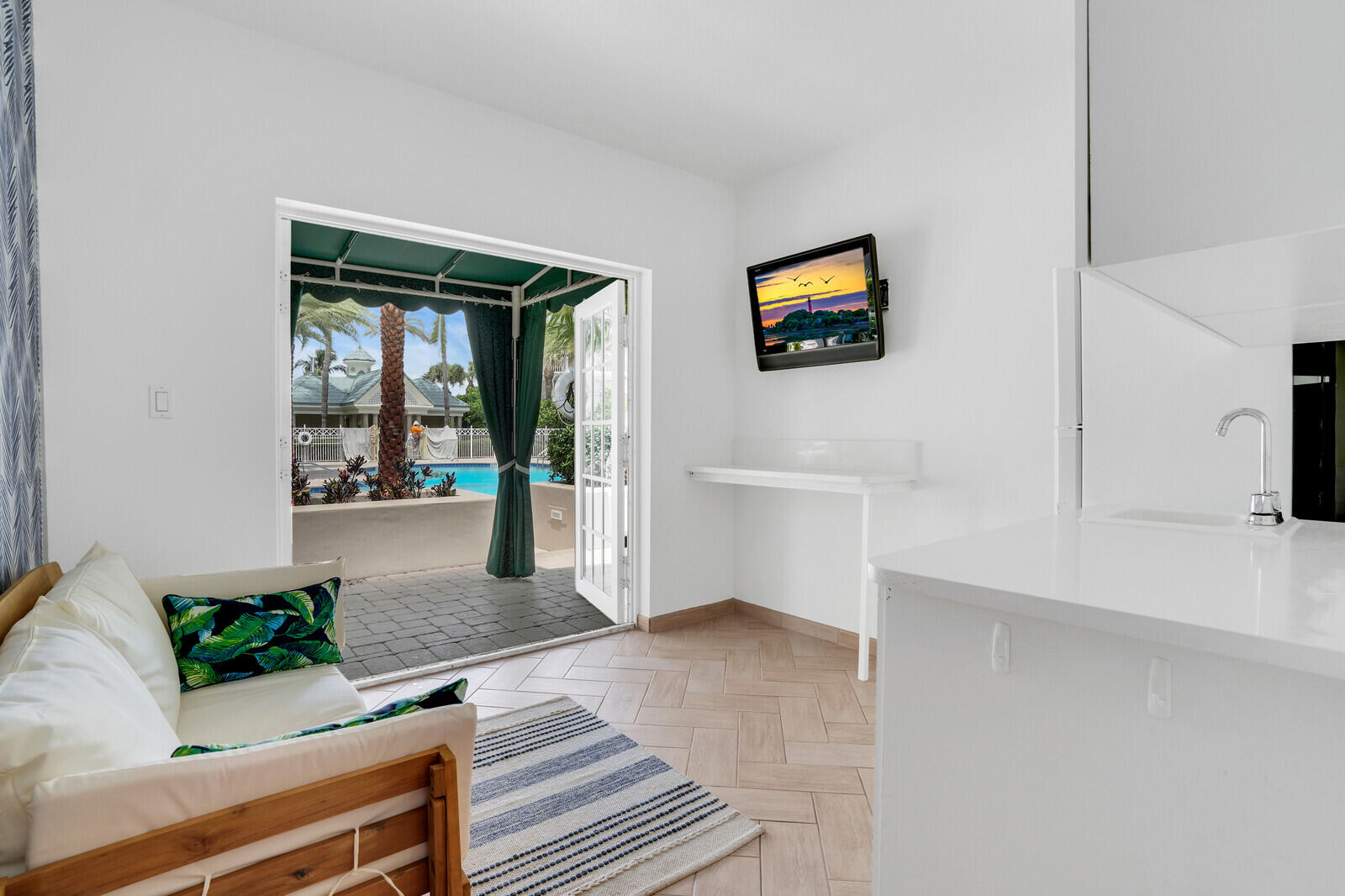 120 Ocean Grande Boulevard, Unit 2 Jupiter, FL 33477 - Photo 32 of 47 a living room with furniture and a flat screen tv