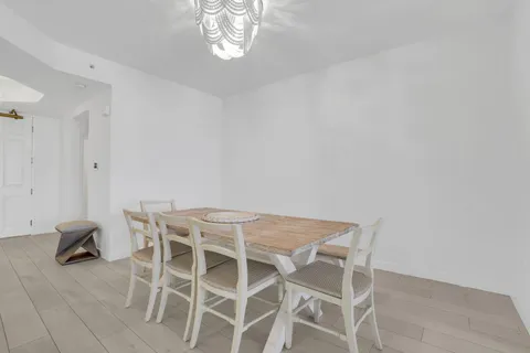 a view of a dining room with furniture and a chandelier