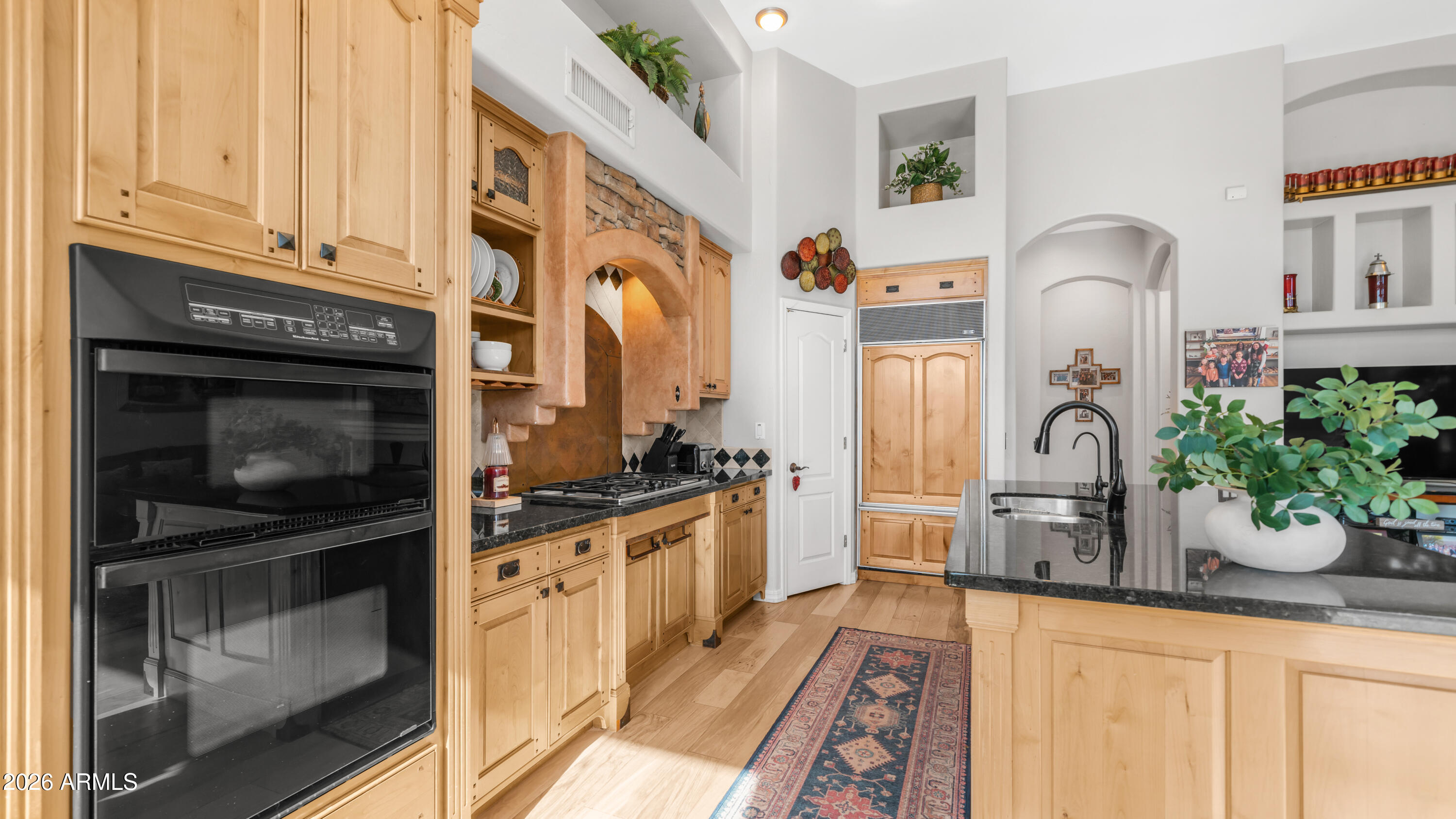 4055 North Recker Road, Unit 50 Mesa, AZ 85215 - Photo 20 of 77 a kitchen with stainless steel appliances granite countertop a stove a sink and a microwave