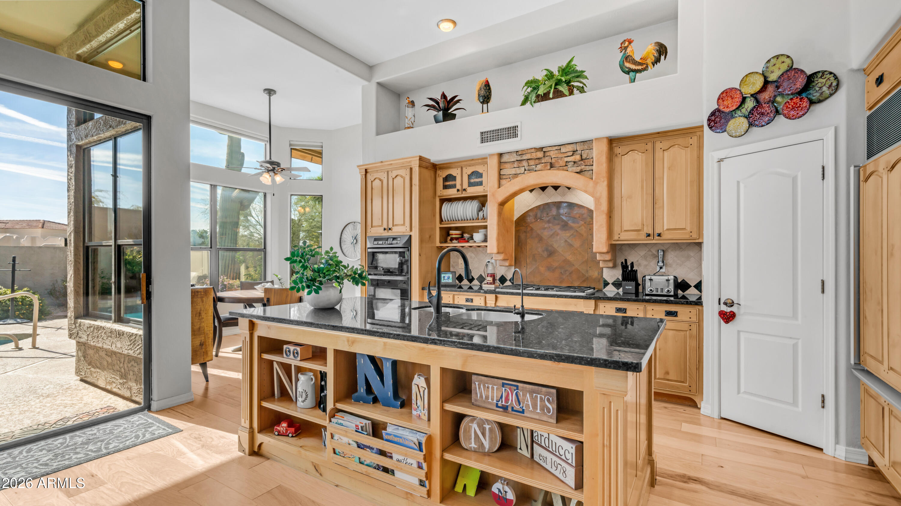 4055 North Recker Road, Unit 50 Mesa, AZ 85215 - Photo 21 of 77 a kitchen with stainless steel appliances granite countertop a stove a sink and a refrigerator