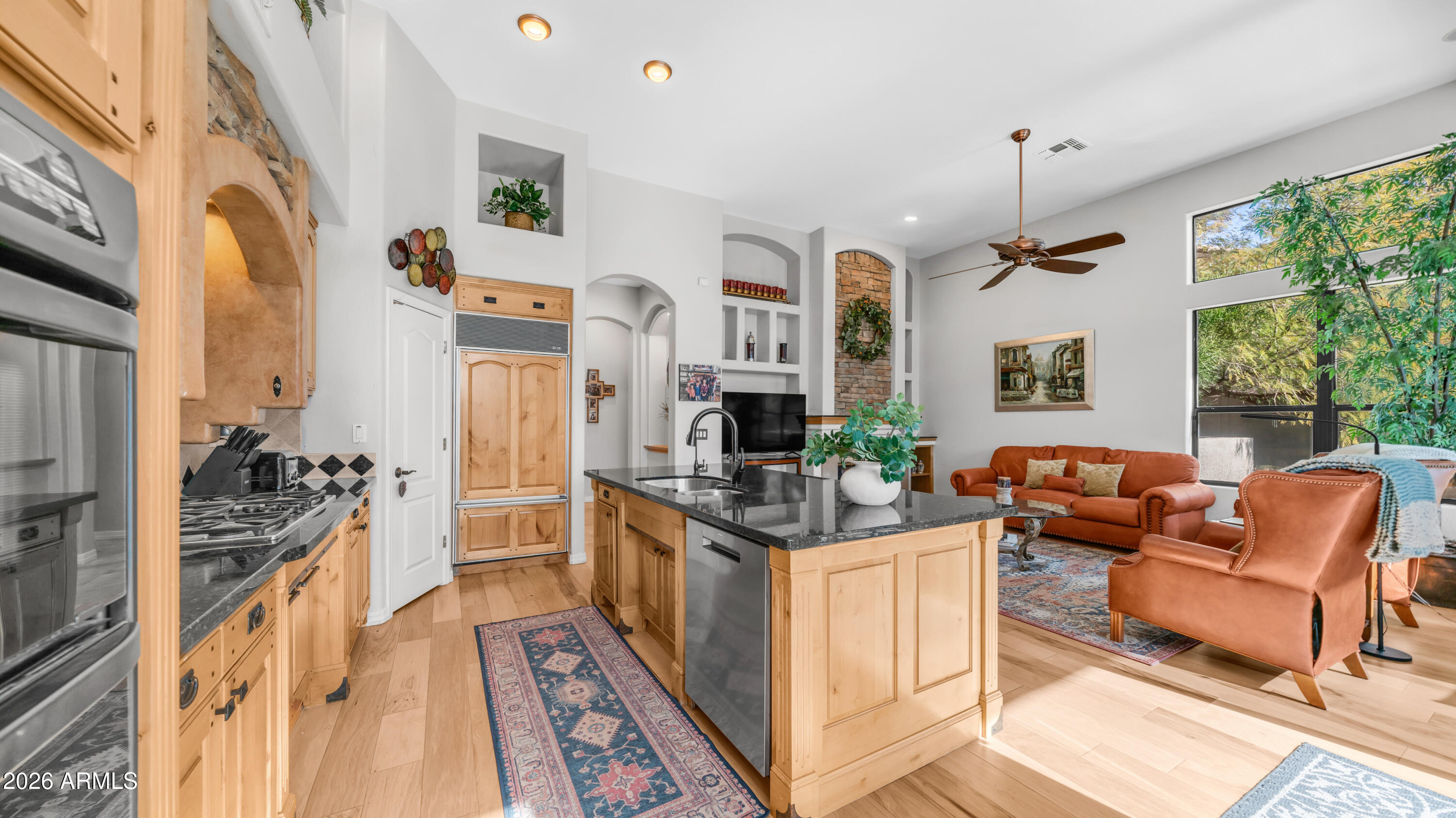 4055 North Recker Road, Unit 50 Mesa, AZ 85215 - Photo 22 of 77 a open kitchen with stainless steel appliances granite countertop a stove and a living room view