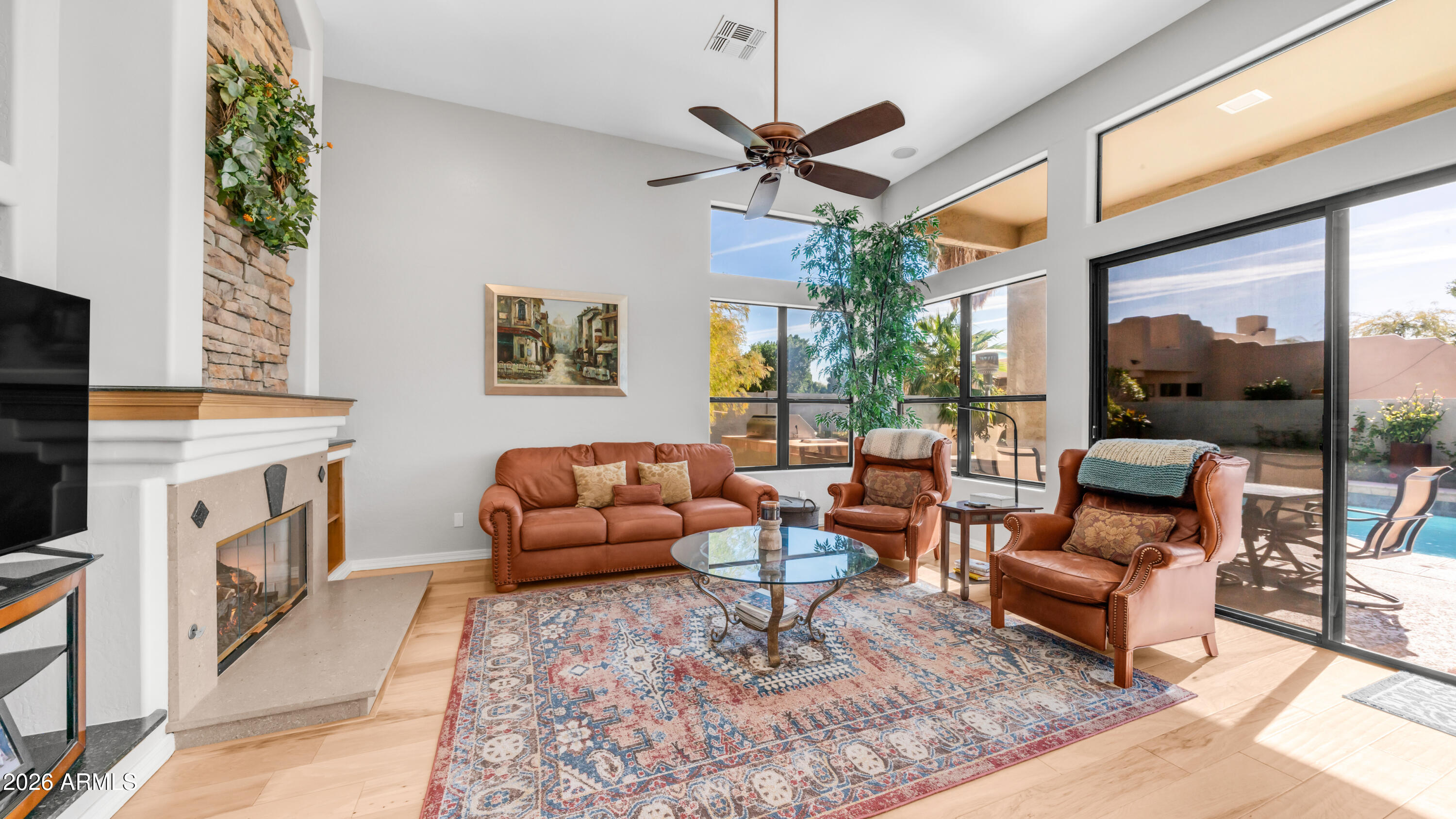 4055 North Recker Road, Unit 50 Mesa, AZ 85215 - Photo 24 of 77 a living room with furniture a fireplace and a flat screen tv